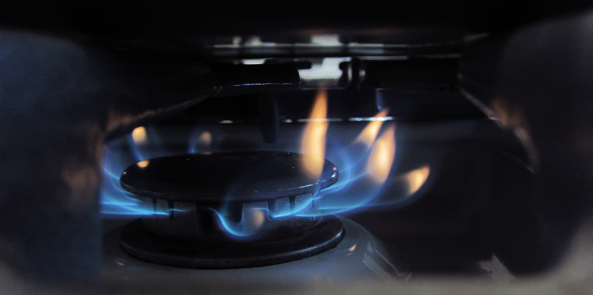 Close-up of a blue flame on a gas stove burner