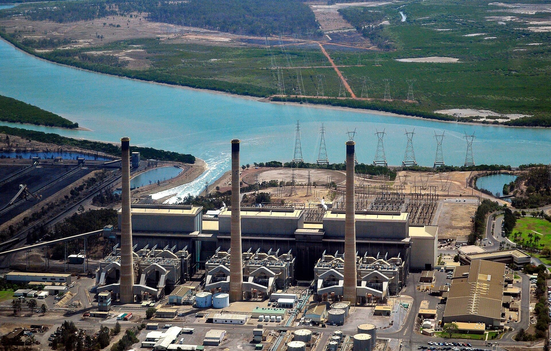 Aerial view of Gladstone Power Station in Queensland, with generating units, coal stockpiles and harbour infrastructure.